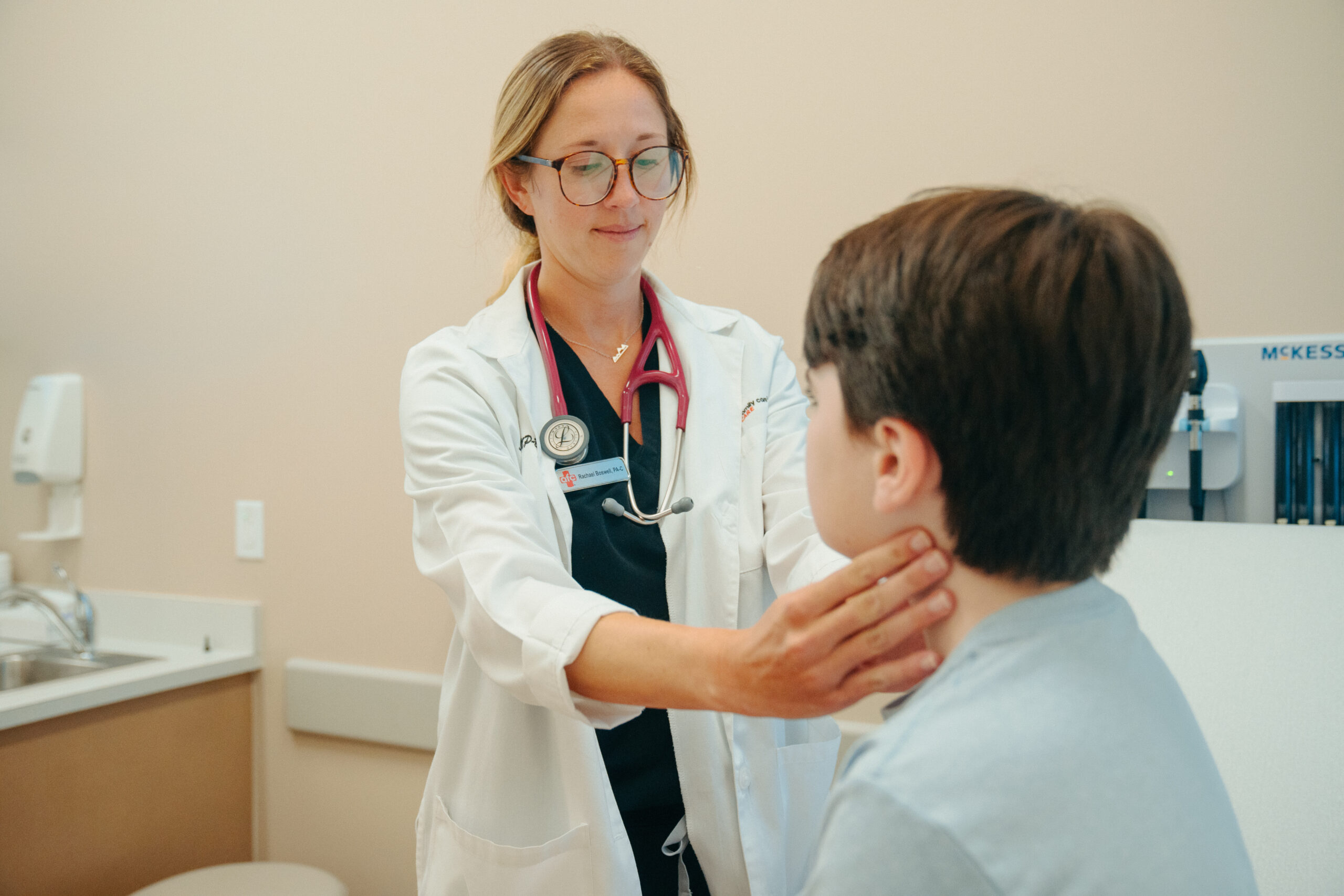 AFC provider checks young patient's lymph nodes